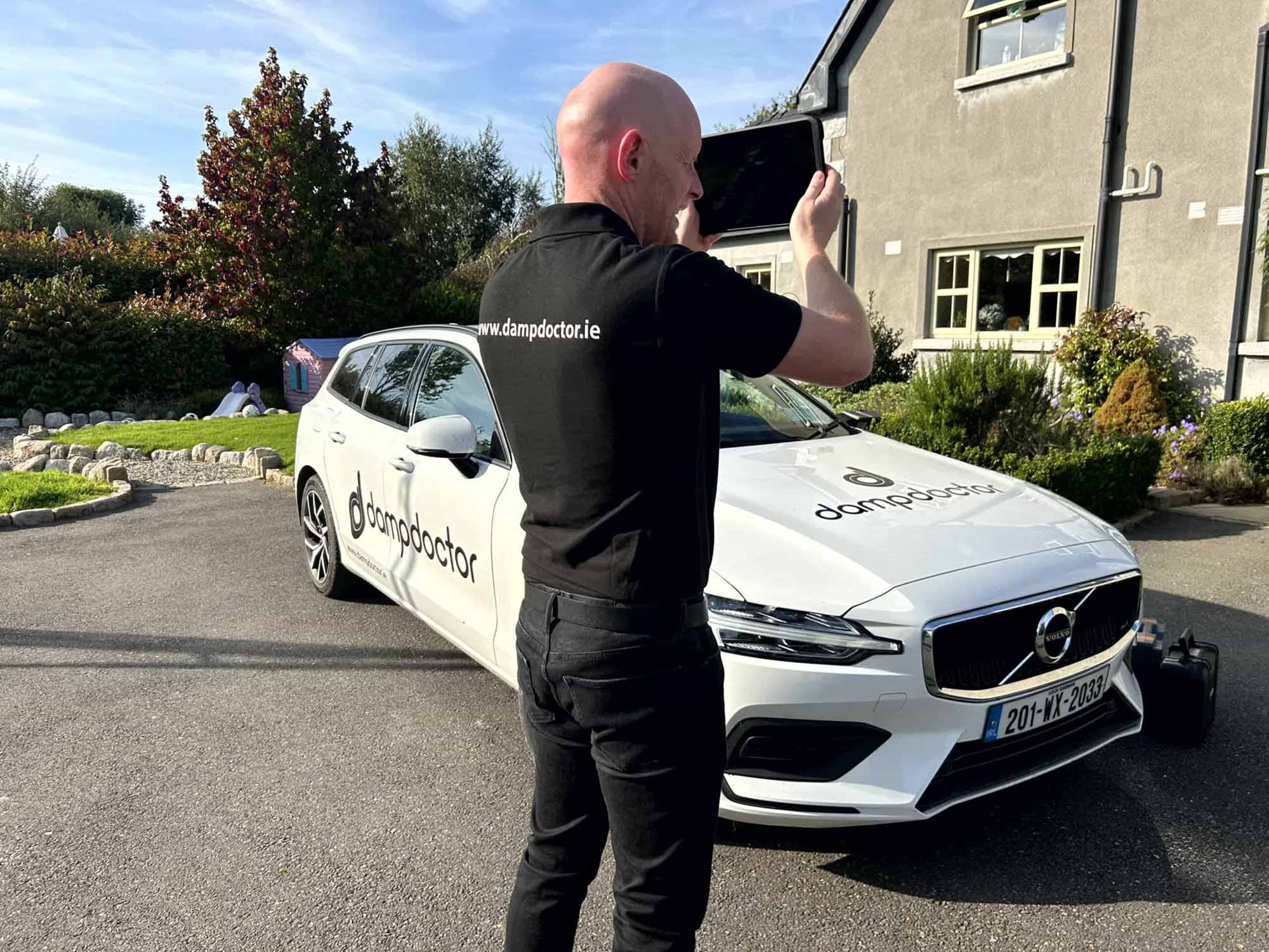 Dampdoctor.ie - Damp Surveyor performing inspection outside
