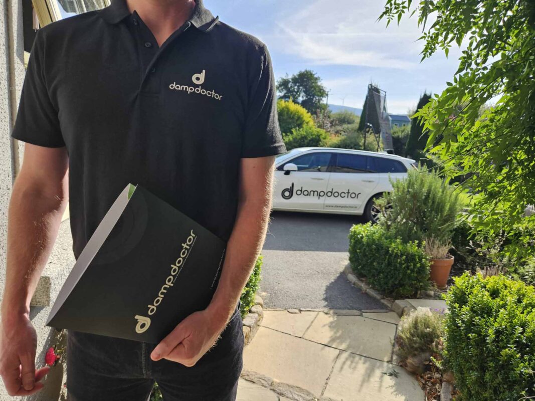 Dampdoctor.ie - Surveyor on customer doorstep with completed report
